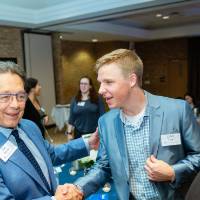 Jim Brooks shaking hands with a student at Scholarship Dinner 2019